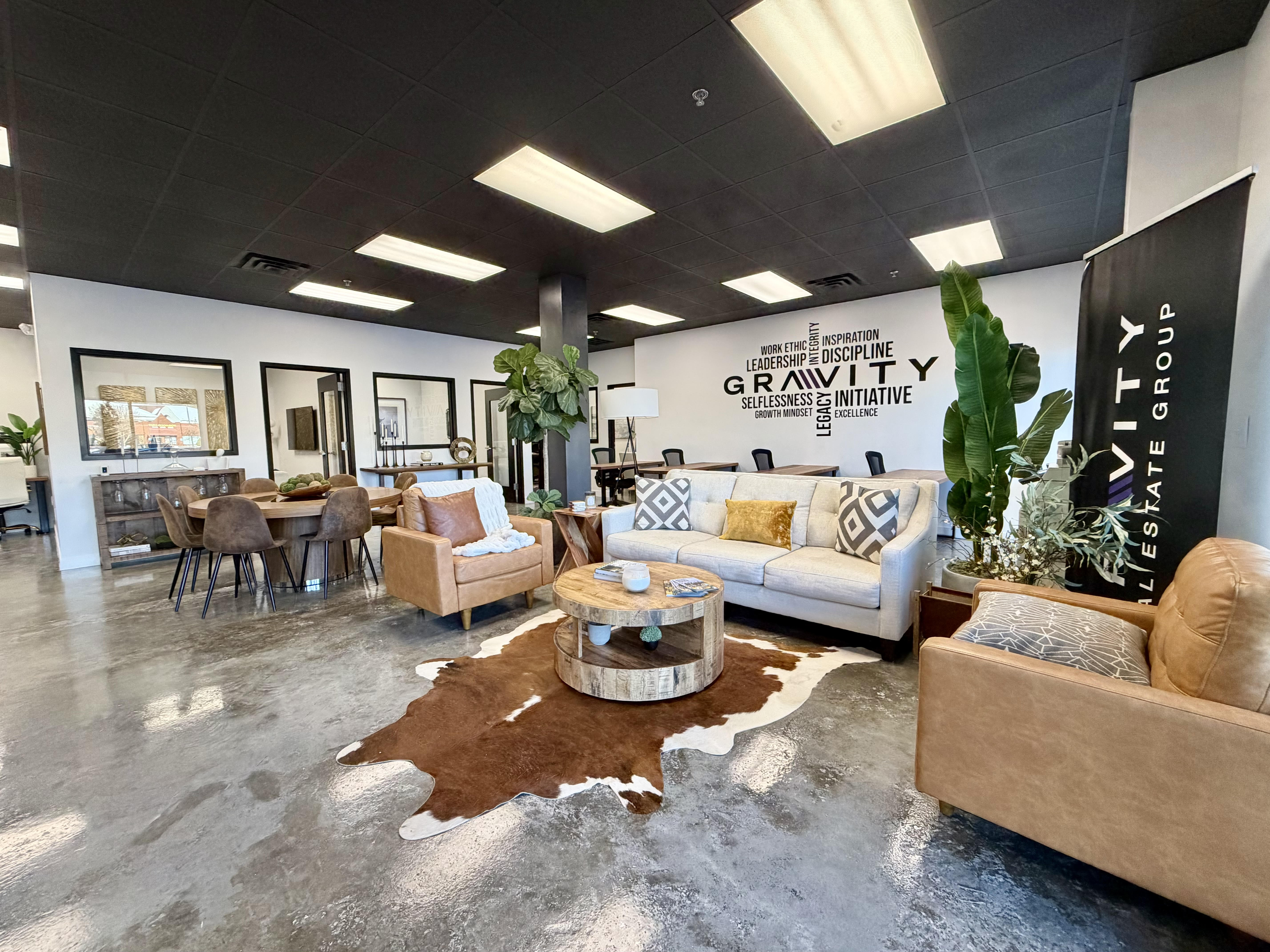 Gravity Real Estate Group modern office with branded values wall, lounge seating, and meeting area